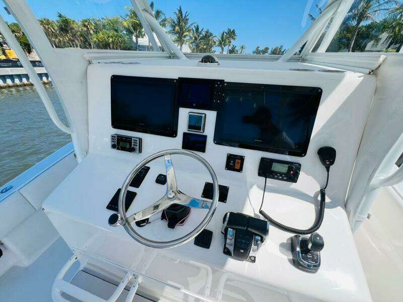 2015 Billfish 39 Custom CC helm with dual screens and navigation controls.