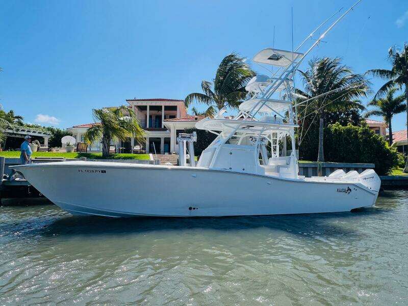 2015 Billfish 39 Custom CC boat docked near a waterfront property.