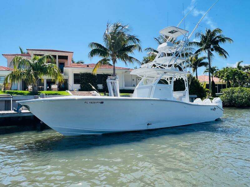 2015 Billfish 39 Custom CC boat docked near a waterfront home.