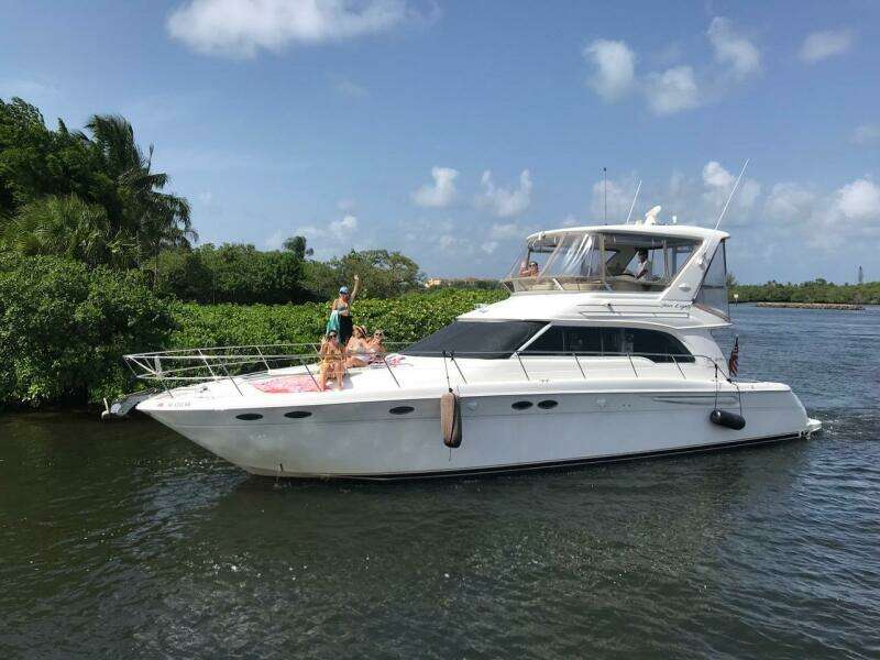 1998 Sea Ray 480 Sedan Bridge yacht cruising on a sunny day.