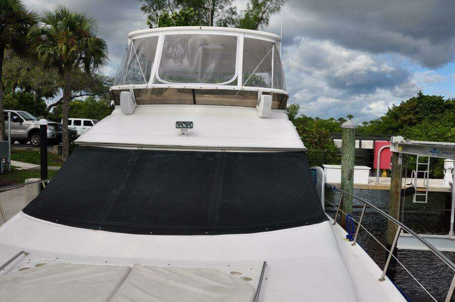 1998 Sea Ray 480 Sedan Bridge yacht docked at marina.