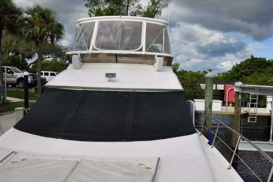 1998 Sea Ray 480 Sedan Bridge yacht docked at a marina.