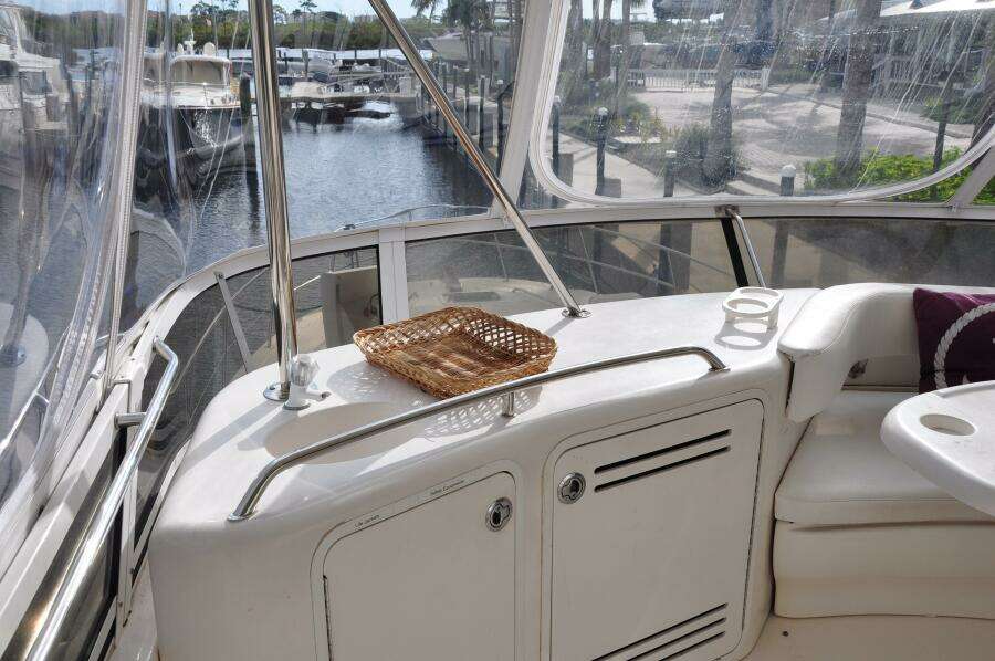 1998 Sea Ray 480 Sedan Bridge yacht interior with marina view.