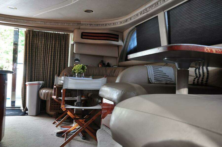 Interior of 1998 Sea Ray 480 Sedan Bridge yacht with seating and dining area.