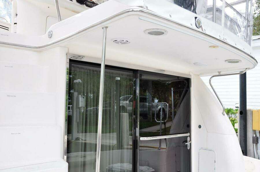 1998 Sea Ray 480 Sedan Bridge yacht, rear deck view with sliding glass door.