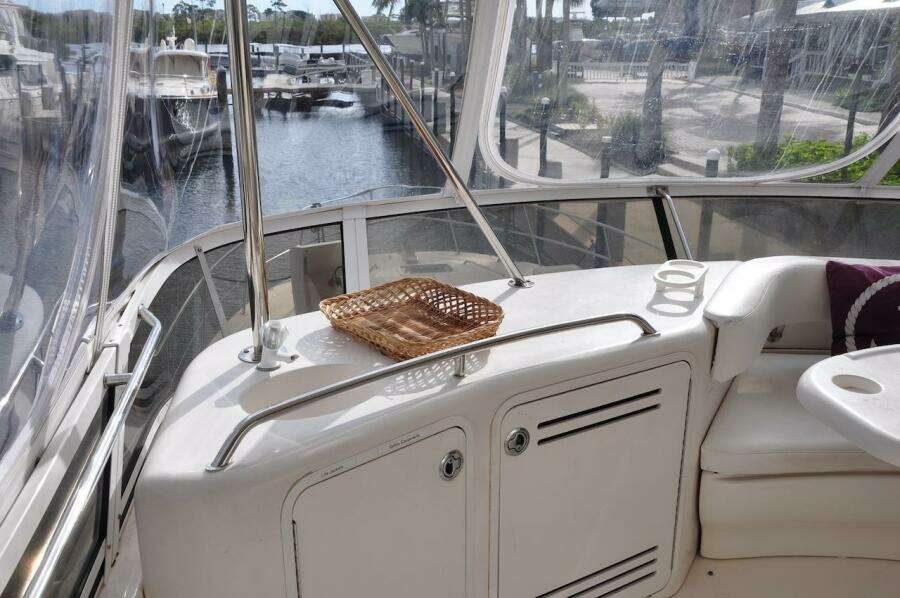 1998 Sea Ray 480 Sedan Bridge yacht interior with marina view.