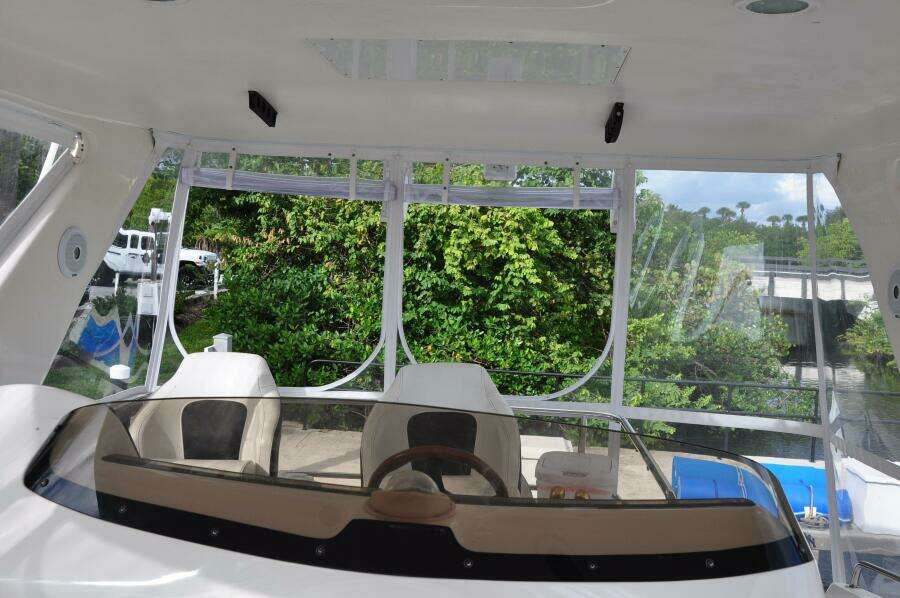 1998 Sea Ray 480 Sedan Bridge cockpit with helm and seating area.