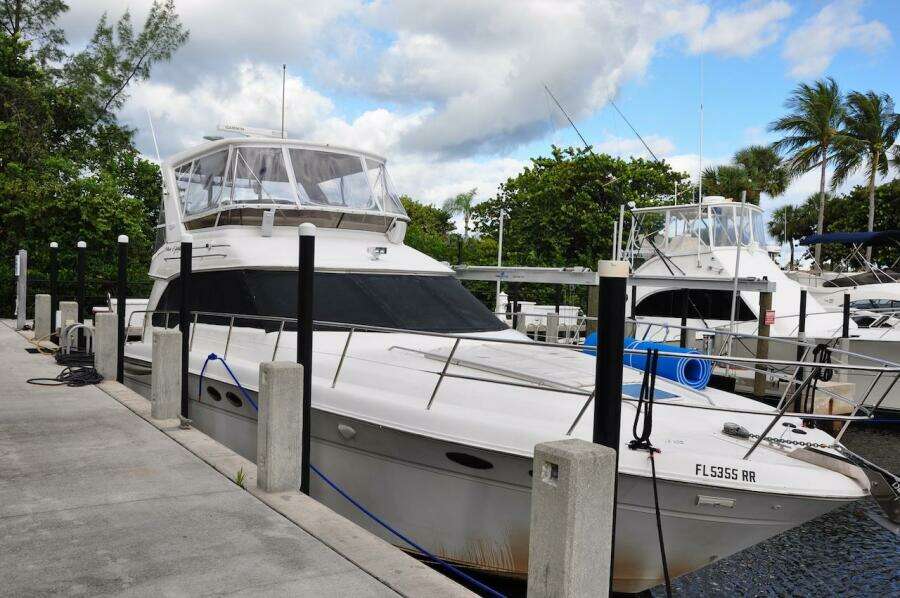 1998 Sea Ray 480 Sedan Bridge yacht docked at marina.