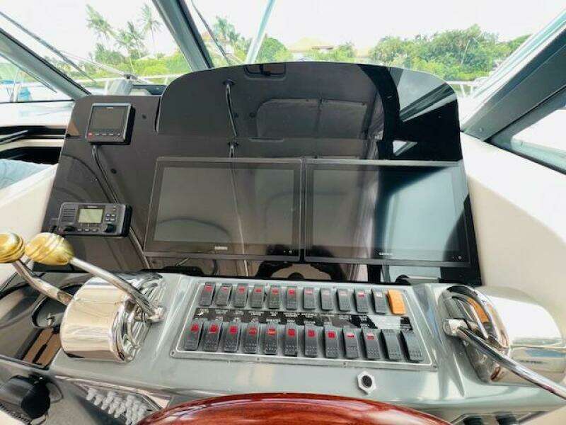Control panel of 2003 Tiara Yachts 3800 Open with dual screens and navigation equipment.