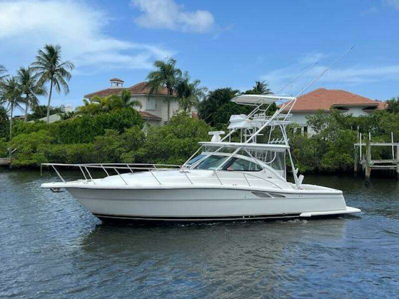 2003 Tiara Yachts 3800 Open cruising on a scenic waterway with lush greenery.