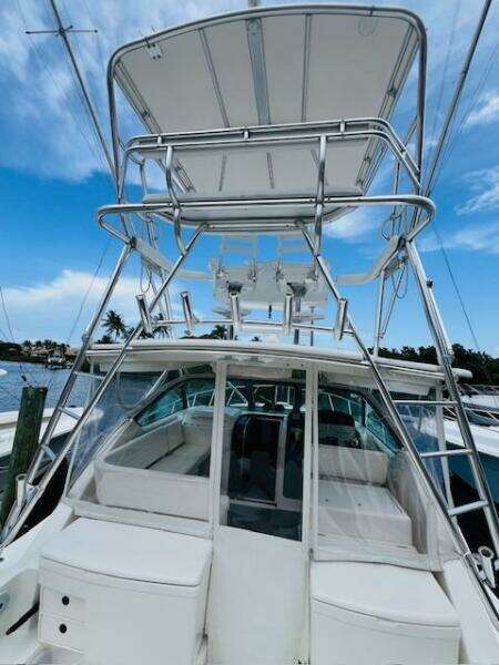 2003 Tiara Yachts 3800 Open with tower, docked under blue sky.