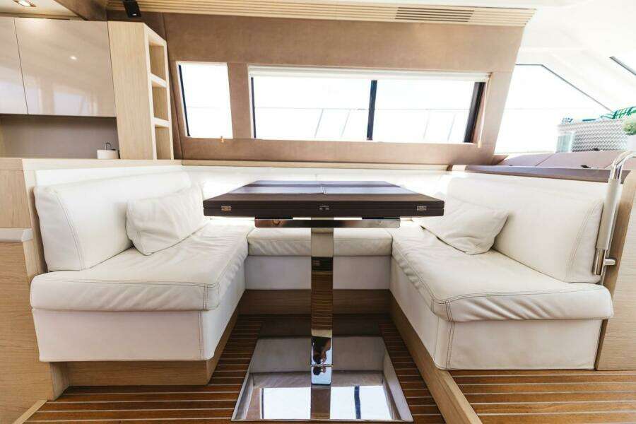 Luxurious interior of 2015 Beneteau Monte Carlo 5 yacht with elegant seating and table.