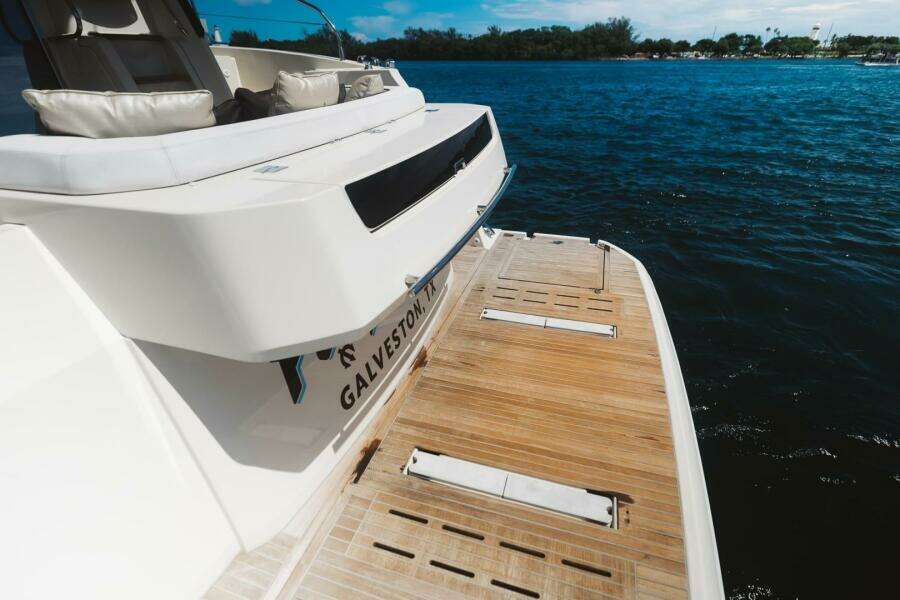 2015 Beneteau Monte Carlo 5 yacht with teak swim platform on calm water.