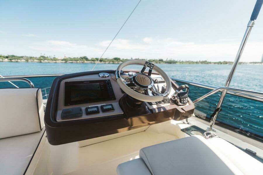 Steering console of 2015 Beneteau Monte Carlo 5 yacht with ocean view.