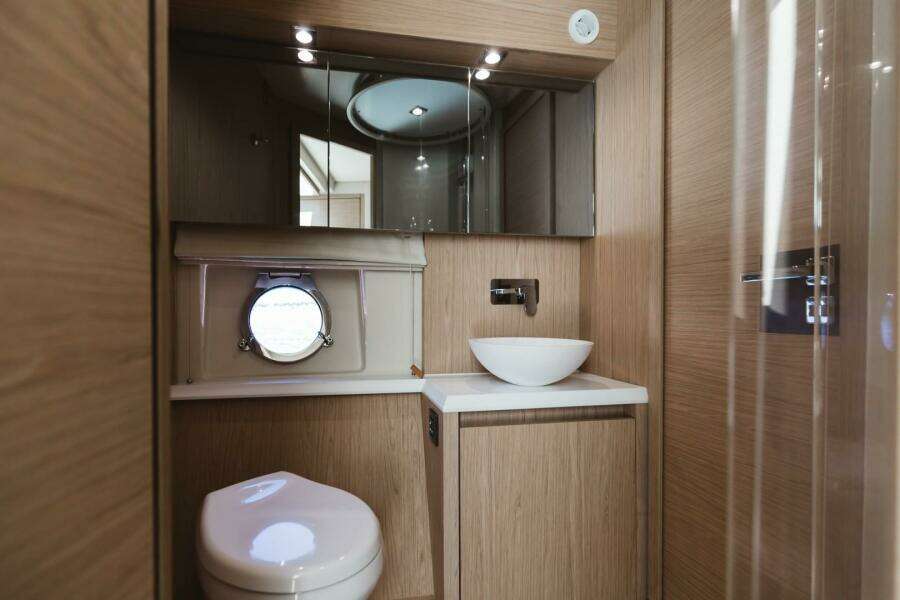 Luxurious bathroom in 2015 Beneteau Monte Carlo 5 yacht with modern fixtures.