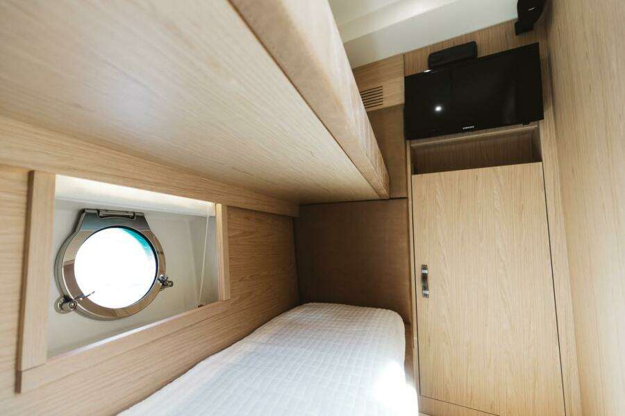 Interior cabin of 2015 Beneteau Monte Carlo 5 yacht with porthole and TV.