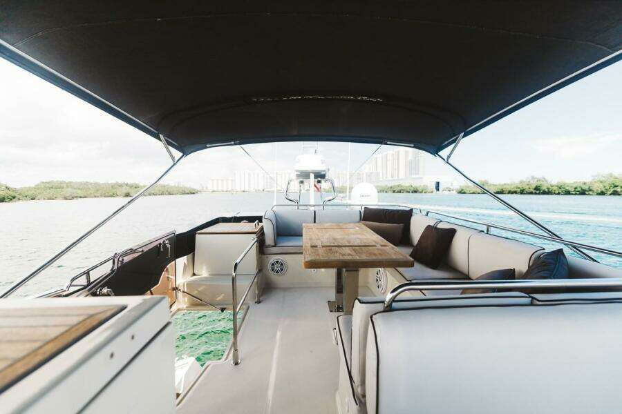 2015 Beneteau Monte Carlo 5 yacht interior with seating and table on deck.