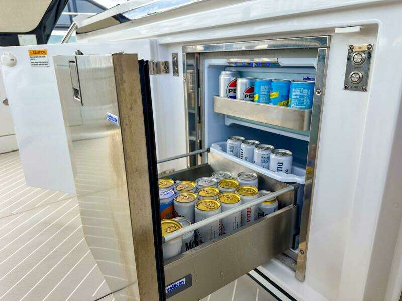 Open fridge on 2023 Azimut Verve 47 yacht, stocked with beverages.