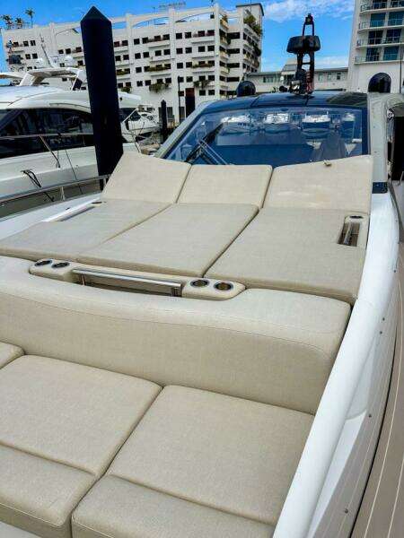 2023 Azimut Verve 47 luxury yacht with spacious sunbathing deck in marina setting.