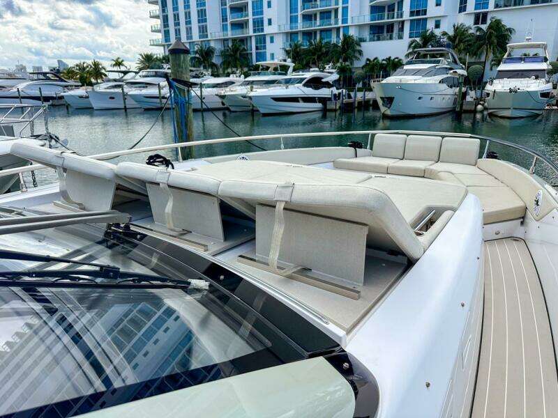 2023 Azimut Verve 47 yacht with luxurious deck seating in a marina setting.