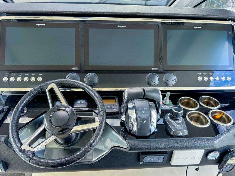Control panel of 2023 Azimut Verve 47 yacht with steering wheel and digital displays.