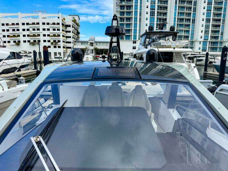 2023 Azimut Verve 47 yacht docked at marina with modern design and cityscape background.