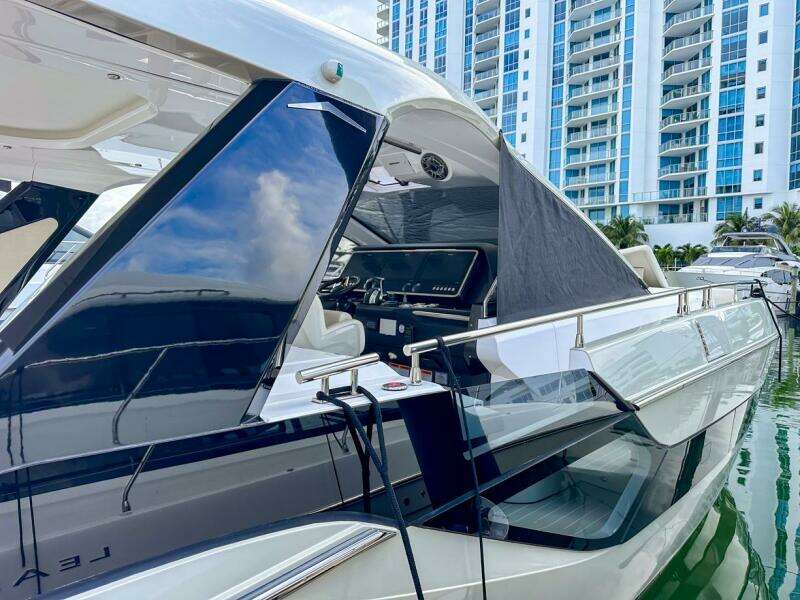 2023 Azimut Verve 47 yacht docked near modern high-rise buildings.