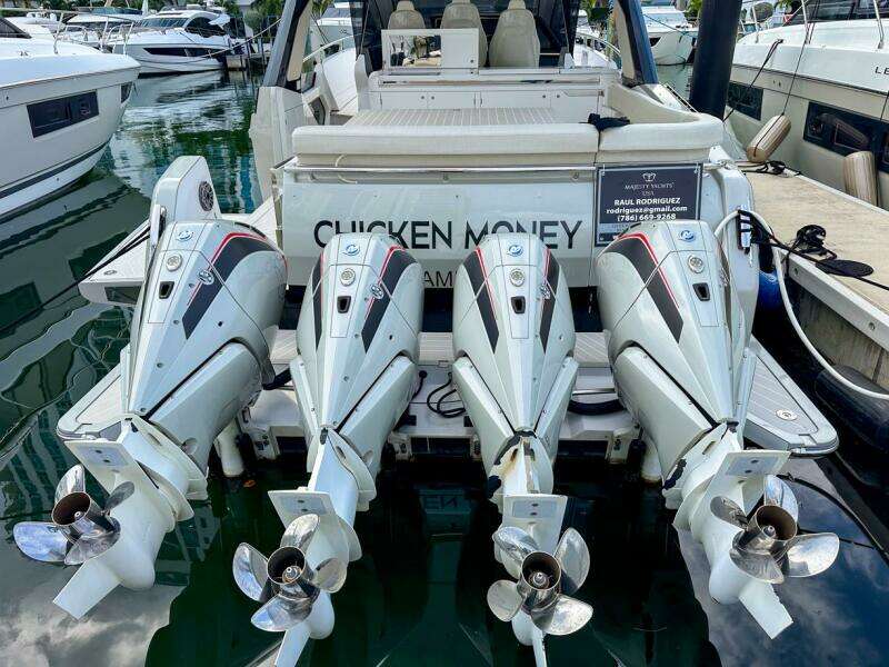2023 Azimut Verve 47 with four powerful outboard engines docked at a marina.