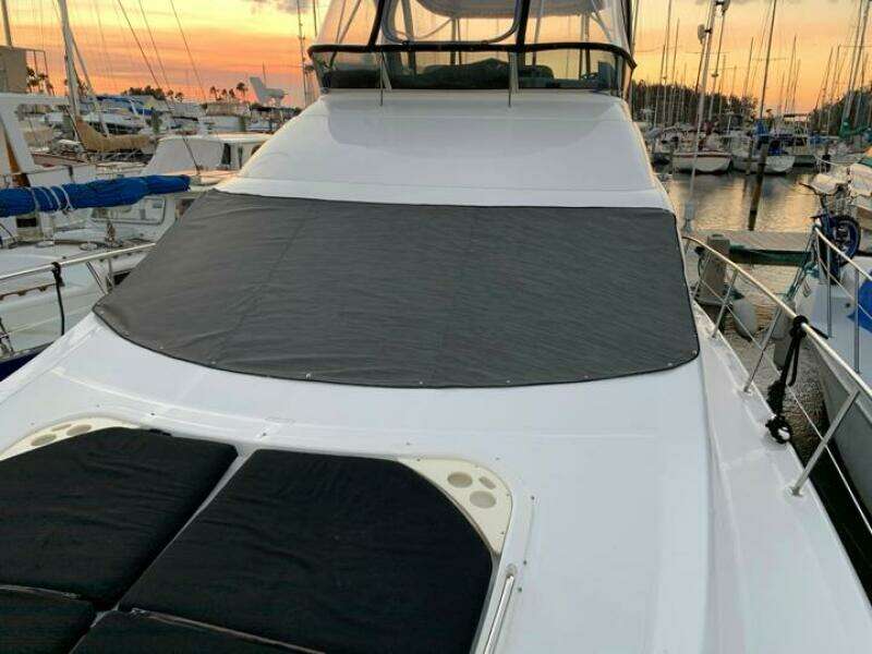 2006 Sea Ray 52 Sedan Bridge yacht docked at sunset.