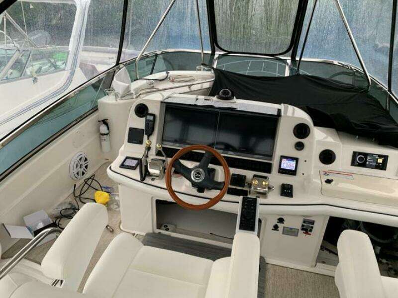 2006 Sea Ray 52 Sedan Bridge helm with modern navigation equipment and leather seating.