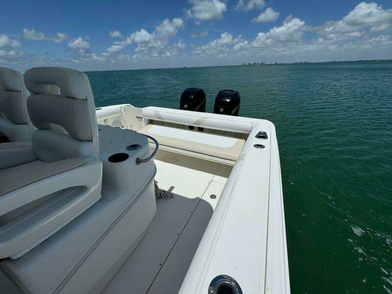 2008 Boston Whaler 320 Outrage boat on open water, featuring dual outboard motors.