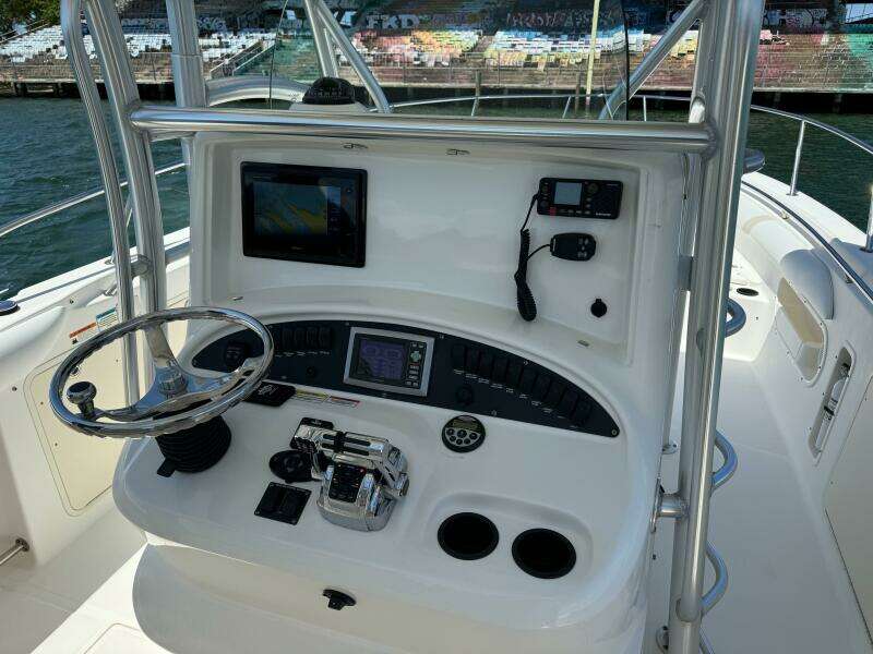 2008 Boston Whaler 320 Outrage helm with navigation equipment and steering wheel.