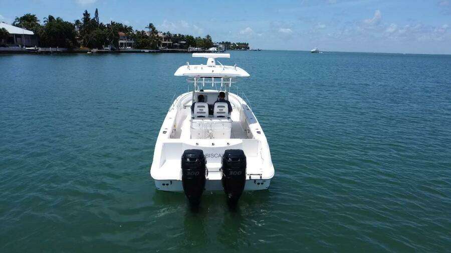 2008 Boston Whaler 320 Outrage boat with twin engines on calm water.