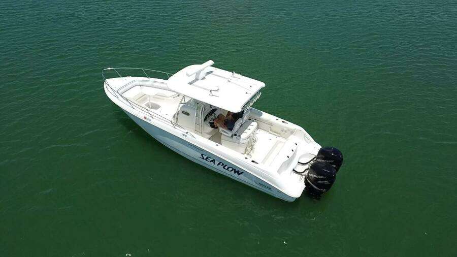 2008 Boston Whaler 320 Outrage boat on calm water.