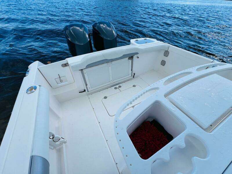 2012 Everglades 295 Center Console boat on water, featuring spacious deck and dual engines.
