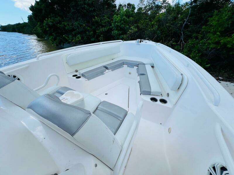 2012 Everglades 295 Center Console boat interior with cushioned seating near water.