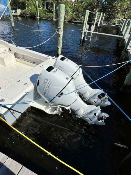 1988 Grady-White 25 Sailfish boat with dual outboard engines docked in marina.