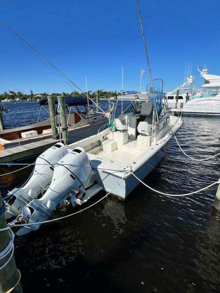 1988 Grady-White 25 SAILFISH boat docked with dual outboard motors.