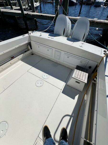 1988 Grady-White 25 Sailfish boat deck with twin engines at marina.