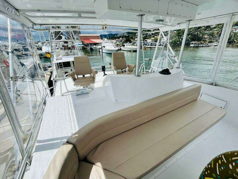 1988 Bertram 54' yacht interior with seating, docked at marina.