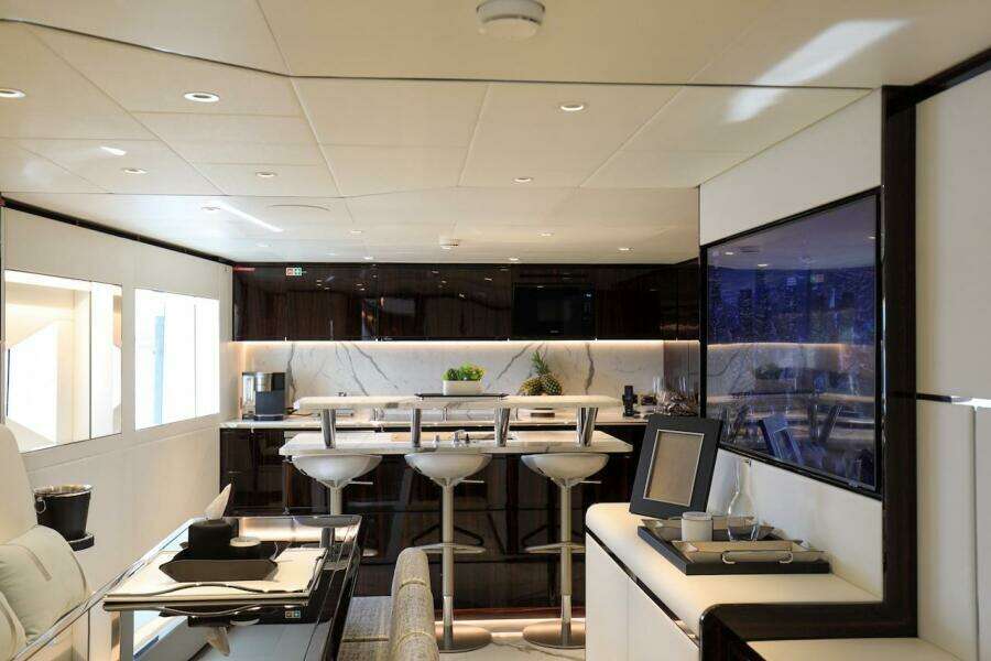 Luxurious interior of 2025 Majesty 120 yacht with modern bar and seating area.