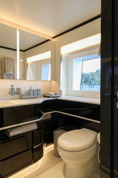 Luxurious bathroom in 2025 Majesty 120 yacht with modern fixtures and large window.