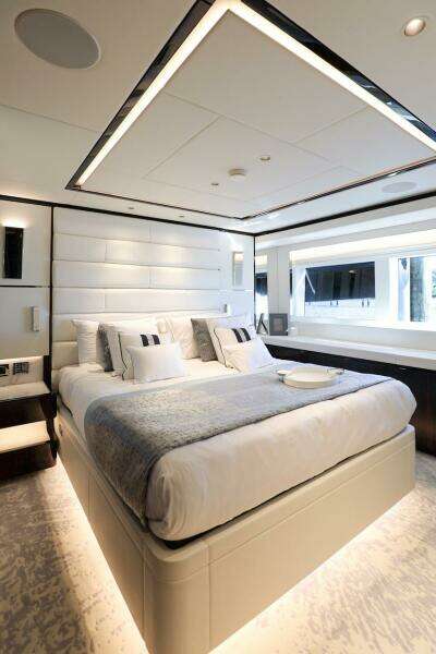 Luxurious bedroom interior on 2025 Majesty 120 yacht, featuring modern design and elegant furnishings.
