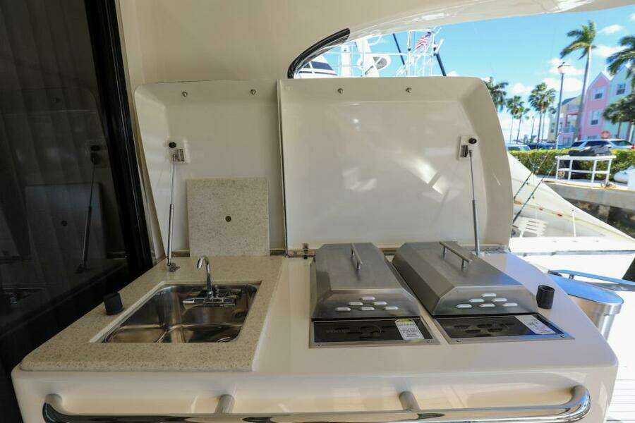 Outdoor kitchen on 2016 Marquis 660 Sport Yacht with sink and grill.