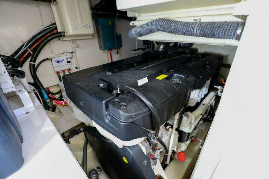 Engine room of 2016 Marquis 660 Sport Yacht, showcasing mechanical components and wiring.