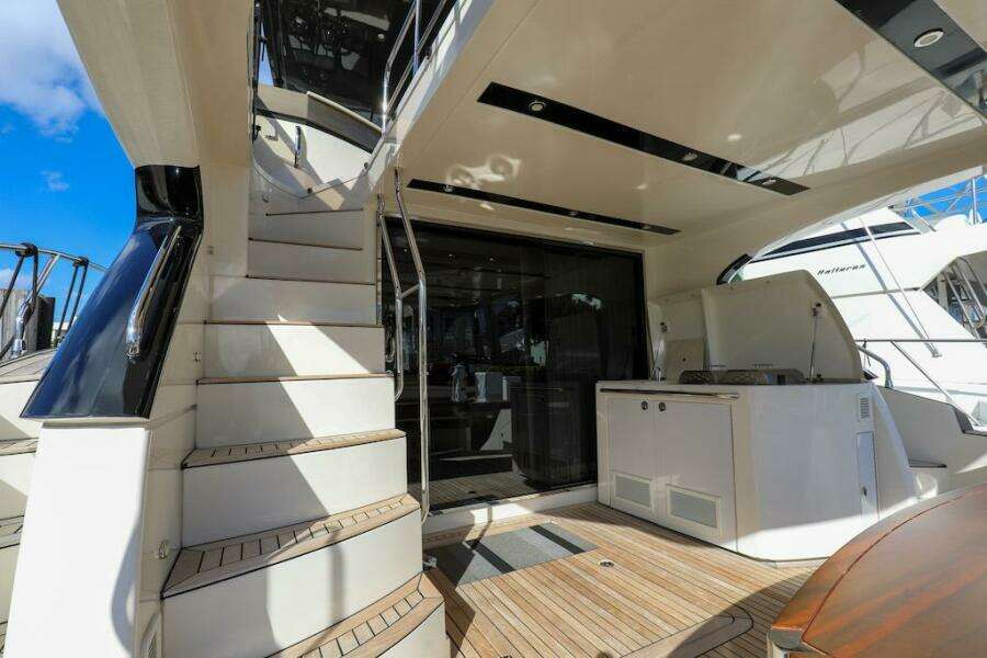 2016 Marquis 660 Sport Yacht deck with stairs and outdoor kitchen.