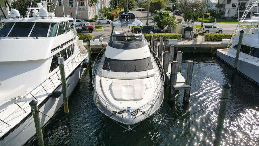 2016 Marquis 660 Sport Yacht docked at marina, aerial view.