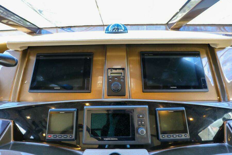 Control panel of 2016 Marquis 660 Sport Yacht with multiple screens and navigation equipment.