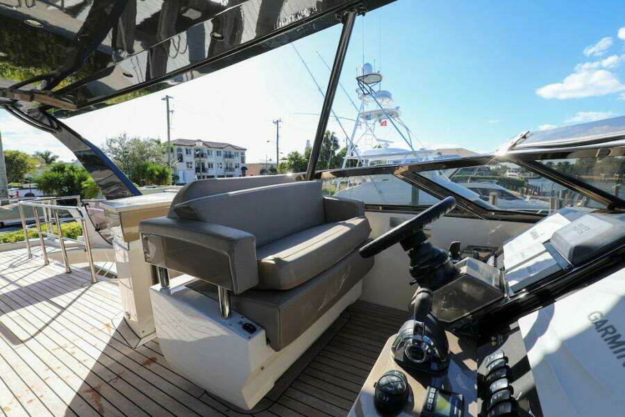2016 Marquis 660 Sport Yacht cockpit with modern controls and seating.