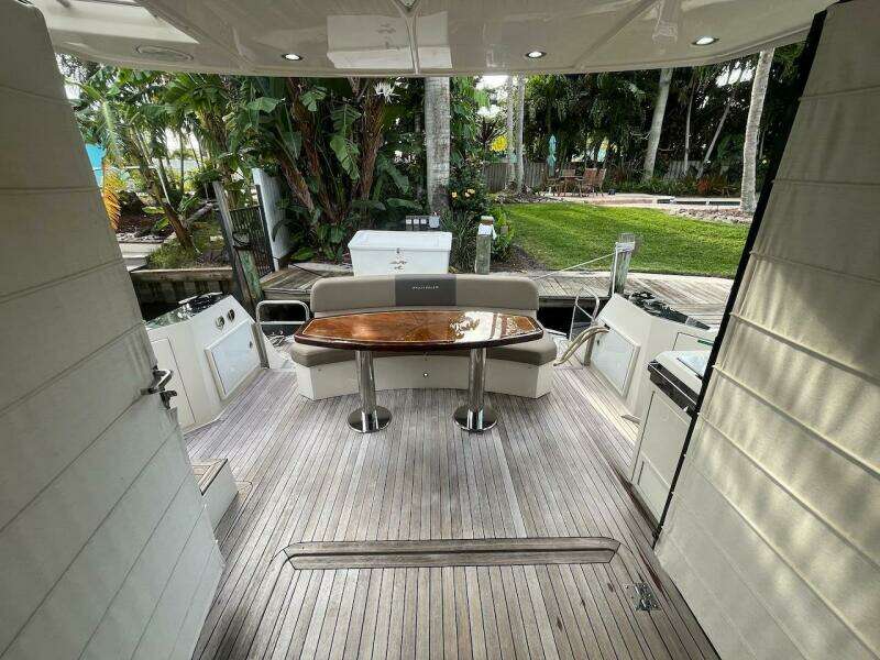 2017 Marquis 500 Sport Yacht deck with wooden table and seating.